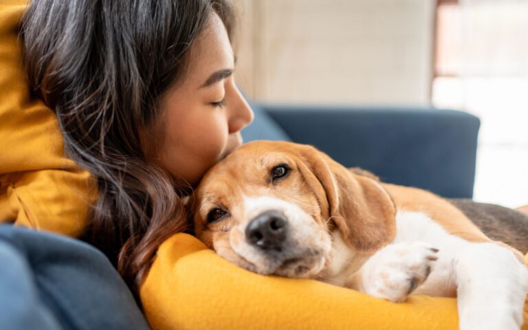 A dog mom snuggling her dog after getting preventive veterinary care in deerfield beach florida